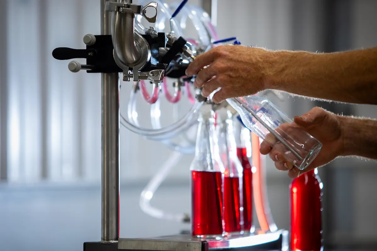 Soda bottles being filled from machine